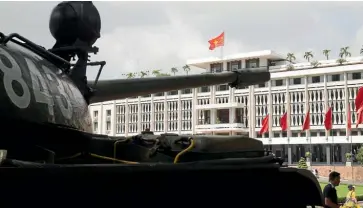  ??  ?? Replicas of the tanks that crashed through the gates of the Reunificat­ion Palace sit outside its entrance today.