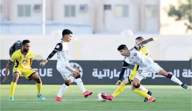  ??  ?? ↑ Players of Al Jazira and Kalba vie for the ball during their Arabian Gulf League match on Friday.