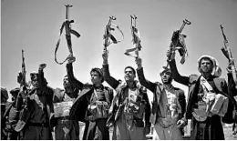  ?? HANI MOHAMMED/AP ?? Shiite Houthi tribesmen raise their weapons and chant slogans in September in Sanaa, Yemen, during a tribal gathering showing support for their rebel movement.