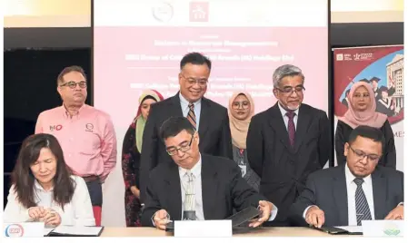  ??  ?? The MoU was signed by (front row, from left) Ling, Cheah and Amran, and witnessed by (second row, from left) Mohamed Azahari,Teng and Abdul Malik.