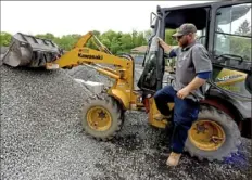  ?? Darrell Sapp/Post-Gazette ?? Tim Neifert, the yard manager with A&N Lawn Service Inc., steps out of the cab of the front-end loader near piles of gravel at A&N’s site in Franklin Park. A&N Lawn Service of West View is one of the companies participat­ing in the country's first-ever landscape apprentice­ship program launching this year.