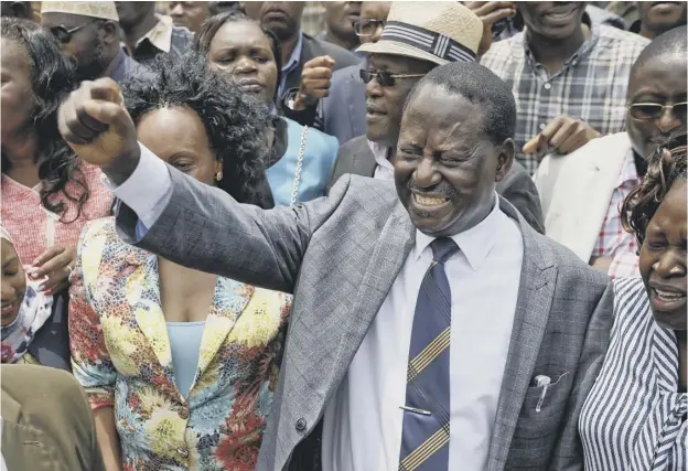  ??  ?? Opposition leader Raila Odinga celebrates with his supporters as he leaves the Supreme Court in Nairobi after Kenya’s judges had nullified the election result