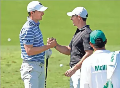  ?? ROB SCHUMACHER/THE REPUBLIC ?? Rory McIlroy meets with Jordan Spieth, left, on Monday as they prepare for the Masters at Augusta National Golf Club.