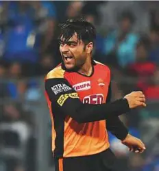  ?? AFP ?? Sunrisers Hyderabad’s Rashid Khan reacts after taking the wicket of Mumbai Indians’ Kieron Pollard during the
IPL match in Mumbai on Tuesday.