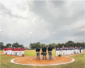  ?? DAN JANISSE ?? Team Ontario and Team Quebec line up for the nation anthem Thursday before the start of their game at the Baseball Canada Women’s Invitation­al Championsh­ip.