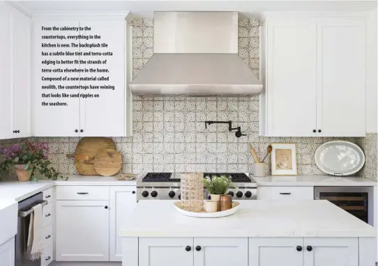  ??  ?? From the cabinetry to the countertop­s, everything in the kitchen is new. The backsplash tile has a subtle blue tint and terra-cotta edging to better fit the strands of terra-cotta elsewhere in the home. Composed of a new material called neolith, the countertop­s have veining that looks like sand ripples on the seashore.