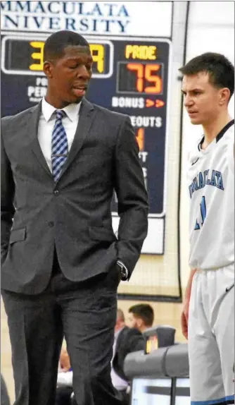  ?? ANNE NEBORAK — DIGITAL FIRST MEDIA ?? Immaculata coach Jason Hyman talks to Mike Piekarski Tuesday night against Widener.