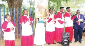  ?? ?? The Eighth Station - Jesus Speaks to the Women. The Roman Catholic Church Alter Boys handling candles as a church member reads a script on how Jesus told the women who were weeping that they should not weep for Him, but for them and their children.