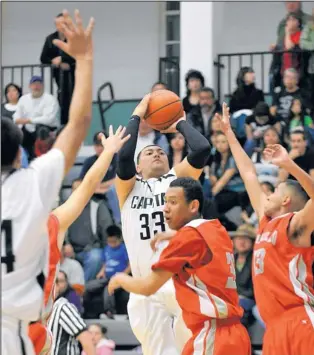  ?? JOURNAL FILE ?? Capital High’s Michael Lopez (33) puts up a 3-point shot over Bernalillo’s Mateo Aragon. Lopez leads this season’s Jaguars, who host the six-team Al Armendariz Classic, beginning today. The tournament — played along with the Lady Jaguar Invitation­al —...