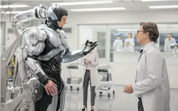  ?? KERRY HAYES/MGM/COLUMBIA PICTURES ?? Joel Kinnaman, left, and Gary Oldman star in the marginally more intelligen­t RoboCop remake.