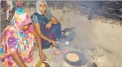  ?? RAJESH KUMAR/ HT PHOTO ?? Two women preparing food on a mud stove at Nagepur village.