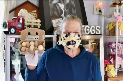  ?? TIMES-STANDARD FILE PHOTOS ?? Kathy Mullen holds up some soap eggs standing in the center of her Kneeland Glen Farm Stand.