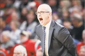  ?? John Minchillo / Associated Press ?? Connecticu­t head coach Dan Hurley directs his players from the bench against Cincinnati on Saturday in Cincinnati.