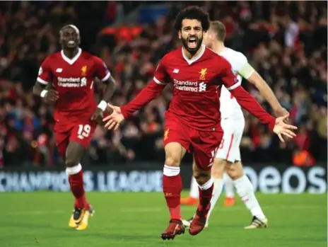  ?? CLIVE BRUNSKILL/GETTY IMAGES ?? Liverpool’s Mohamed Salah celebrates after scoring his team’s seventh goal during Champions League play against Spartak Moskva at Wednesday.