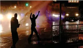  ?? REUTERS ?? Clashes: Rioters react as police use water cannon on youths last night