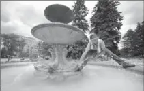  ?? RECORD FILE PHOTO ?? Jim Kenzie, of the Kitchener Horticultu­ral Society, adjusts the water flow on the Janzen Family fountains in the Rockway Gardens in 2013.