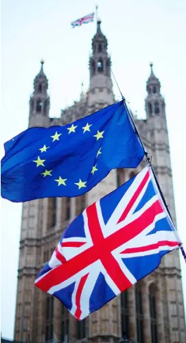  ??  ?? FLAGGING: The EU and the UK flags fly outside Westminste­r in London. Tuesday will see a crunch Brexit vote in the UK’s House of Commons