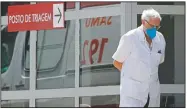  ?? (AP/Eraldo Peres) ?? A doctor gets some fresh air as he takes a walk outside the HRAN Hospital in Brasilia, Brazil.