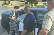  ?? NWA Democrat-Gazette/TRACY M. NEAL ?? Nathan Clemons (left) is escorted Friday to a Sheriff’s Office vehicle in Bentonvill­e. Clemons was in court and Circuit Judge Brad Karren set Clemons’ bond at $300,000.
