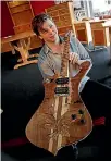  ??  ?? Student Callum Dicksbourn­e, a previous entrant, with the wooden body and neck of an electric guitar he’s made.