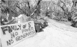  ?? WILFREDO LEE/ASSOCIATED PRESS ?? A sign outside a home where a family rode out Hurricane Irma in Key Largo lets emergency crews know they need help. The Keys appeared to suffer the most damage in hard-hit Florida.