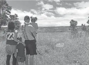  ?? AP ?? In this Sept. 22, 2018, photo released by the National Park Service, tourists visit Hawaii Volcanoes National Park on the first day the park reopened after volcanic activity forced the park to close for more than four months in Hawaii. Renting a car can be essential to see some sites in the state.