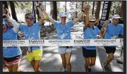  ?? ?? Aneta Zeppettell­a, center, finishing the 135-mile Badwater run across Death Valley to Mt. Whitney Portal in California in July 2021. She is surrounded by her support team, from left, Leanne Hood , Carissa Derr, Ruth