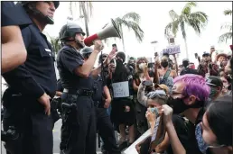  ?? GARY CORONADO/LOS ANGELES TIMES ?? Los Angeles Chief of Police Michel Moore address protesters at 3rd and Fairfax in front of the Farmers Market on Saturday.