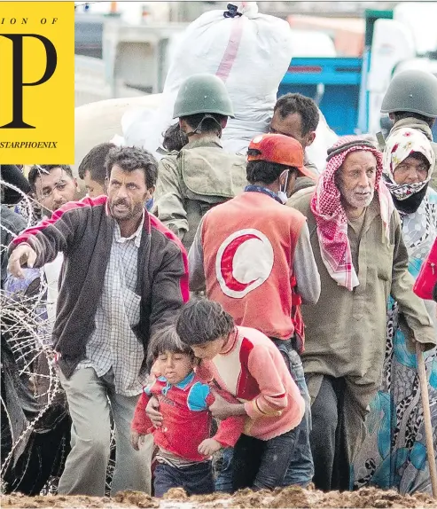  ?? CARSTEN KOALL/GETTY IMAGES ?? Syrian refugees wait to enter Turkey in Yumurtalik in 2014. Today, Turkey is moving toward “a medium- to long-term integratio­n policy” for them.