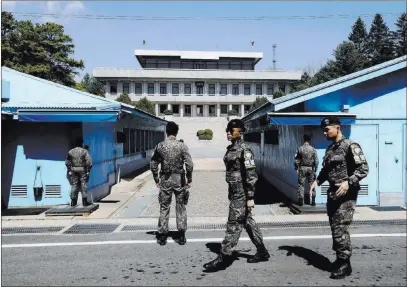  ?? Ahn Young-joon ?? The Associated Press South Korean army soldiers stand guard April 11 at the border villages of Panmunjom in Paju, South Korea. President Donald Trump on Tuesday gave his “blessing” for North and South Korea to discuss the end of the Korean War at their...