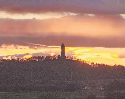  ?? ?? Fiery sky The National Wallace Monument against the backdrop of a stunning sunset, by BA Wilson, Causewayhe­ad