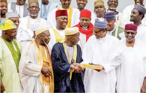  ?? STATE HOUSE ?? President Muhammadu Buhari receives a Quran and Tasbih (prayer beads) from Grand Khalifa of Tijaniyya Movement, Sheikh Mahir Ibrahim Inyass (3rd left), during a visit by a delegation of the movement to the Presidenti­al Villa in Abuja yesterday. With...