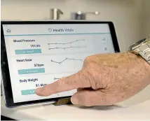  ??  ?? The health monitoring includes taking a person’s blood pressure, pulse and weight.