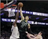  ?? MATT SLOCUM — THE ASSOCIATED PRESS ?? Boston Celtics guard Jayson Tatum goes up for a shot between the Philadelph­ia 76ers’ Joel Embiid, left, and Ersan Ilyasova during the second half of Game 3 Saturday. Tatum led all scorers with 24 points in Boston’s win.