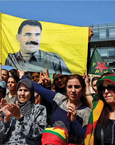  ?? AP ?? Kurdistan Workers’ Party supporters hold a poster of the jailed leader Abdullah Ocalan in Beirut yesterday