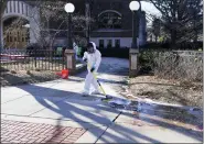  ?? CARLOS OSORIO — THE ASSOCIATED PRESS ?? Workers clean up outside Berkey Hall at Michigan State University, Tuesday, Feb. 14, 2023, in East Lansing, Mich. Police say the gunman who killed himself hours after fatally shooting three students at Michigan State University was 43-year-old Anthony McRae. Police also say five people who are in critical condition Tuesday are also students.