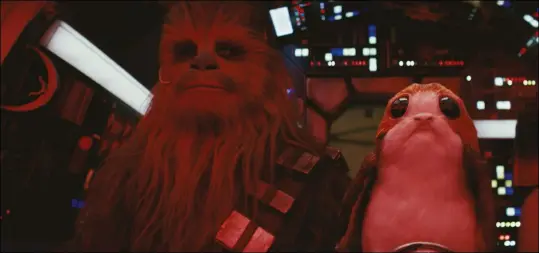  ??  ?? Chewbacca is joined by a porg in the cockpit of the Millennium Falcon. neal Scanlan’s animatroni­c porgs were used handin-hand with ilm’s digital creations