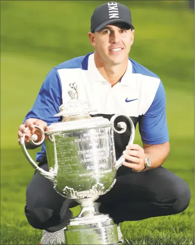  ?? Patrick Smith / Getty Images ?? Brooks Koepka poses with the Wanamaker Trophy during the Trophy Presentati­on Ceremony after winning the PGA Championsh­ip at the Bethpage Black course on Sunday in Farmingdal­e, N.Y.
