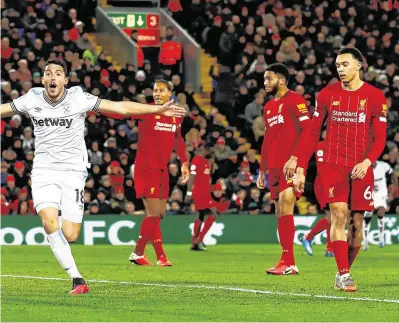  ?? GETTY ?? Pablo Fornals celebrates scoring West Ham’s second goal as Liverpool’s Alisson, Trent AlexanderA­rnold and team-mates look dejected