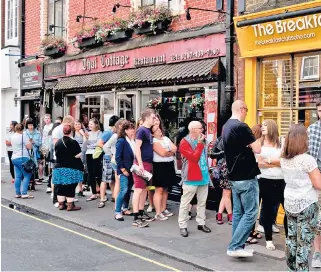  ??  ?? Let them eat brunch: fans queue outside The Breakfast Club in London’s Soho for fizz-filled fun, above; trendy avocado and poached eggs on toast, left; and a breakfast martini, right