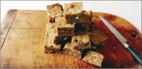  ?? ELIZABETH KARMEL VIA AP ?? This photo shows toffee bars in Amagansett, N.Y. They are packed full of pecans, toffee bits, chopped white chocolate and dried coconut but the sprinkling of bourbon is what really takes them over the edge.