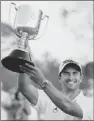  ?? Patrick Hamilton/AFP/Getty Images ?? Adam Scott holds up the Joe Kirkwood Cup after winning the Australian PGA Championsh­ip at Royal Pines on the Gold Coast Sunday.