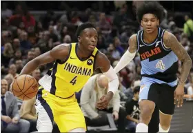  ?? TONY DEJAK — THE ASSOCIATED PRESS ?? The Pacers’ Victor Oladipo, left, drives against Kevin Porter Jr. in the second half Feb. 29 at Rocket Mortgage FieldHouse.
