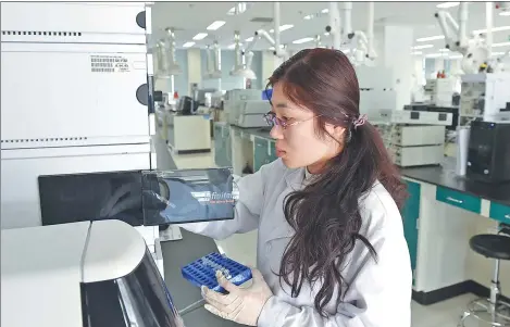  ?? XINHUA ?? A technician tests a dairy product of Yili Industrial Group Co at the company's innovation lab in Hohhot, capital of the Inner Mongolia automous region.