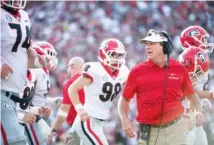  ?? AP PHOTO/SEAN RAYFORD ?? Georgia football coach Kirby Smart greets his players after Rodrigo Blankenshi­p (98) kicked an extra point during the Bulldogs’ 41-17 win last Saturday at South Carolina. Georgia returns to nonconfere­nce play in this weekend’s home game against Middle Tennessee State.