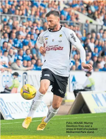  ??  ?? FULL HOUSE: Murray Davidson fires over a cross in front of a packed McDiarmid Park stand.