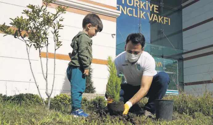  ??  ?? A man plants a sapling in the courtyard of the Turkey Youth Foundation (TÜGVA) as part of the foundation’s planting campaign, in Istanbul, Turkey, Oct. 14, 2020.