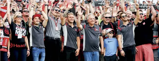  ??  ?? Team spirit: Steiner with the Haas F1 crew – including drivers Kevin Magnussen and Romain Grosjean, and team owner Gene Haas