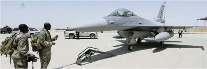  ?? /Reuters ?? Difficult decisions: Soldiers look at an F-16 fighter jet. Four nations have so far committed to a coalition to help train Ukrainian pilots to fly the fighters, but only Denmark and the Netherland­s may end up actually sending the jets to help counter Russia’s invasion.