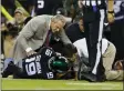  ?? ADAM HUNGER - THE ASSOCIATED PRESS ?? Trainers check on New York Jets quarterbac­k Trevor Siemian (19) after he was injured during the first half of an NFL football game against the Cleveland Browns, Monday, Sept. 16, 2019, in East Rutherford, N.J.